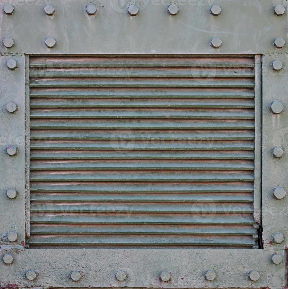 The texture of the wall of the tank, made of metal and reinforced with a multitude of bolts and rivets. Images of the covering of a combat vehicle from the Second World War photo