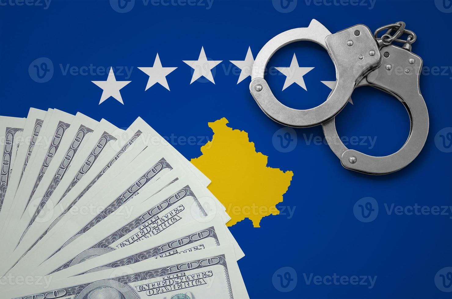 Kosovo flag with handcuffs and a bundle of dollars. The concept of illegal banking operations in US currency photo