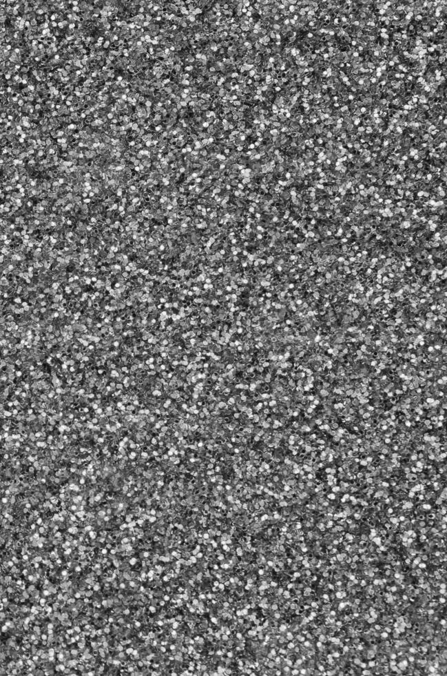 Silver decorative sequins. Background image with shiny bokeh lights from small elements photo