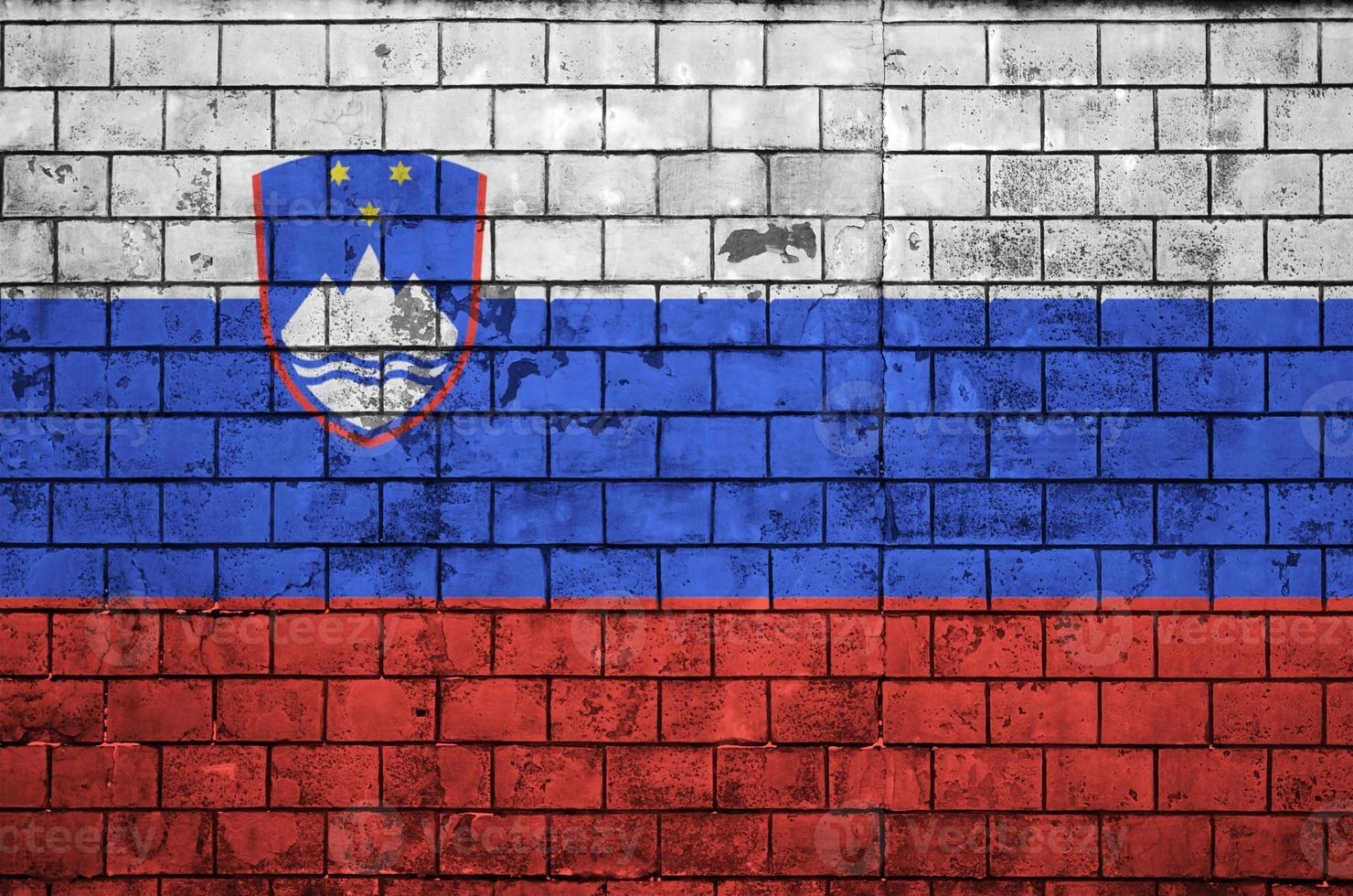Slovenia flag is painted onto an old brick wall photo