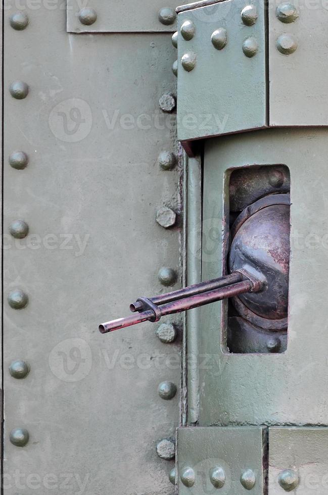 The texture of the wall of the tank, made of metal and reinforced with a multitude of bolts and rivets. Images of the covering of a combat vehicle from the Second World War with a guided machine gun photo