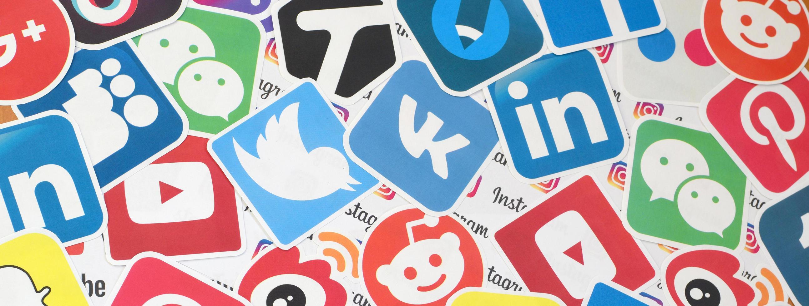 KHARKOV, UKRAINE - MAY 3, 2022 Many paper logos of popular social networks and internet resources. Colorful banner photo