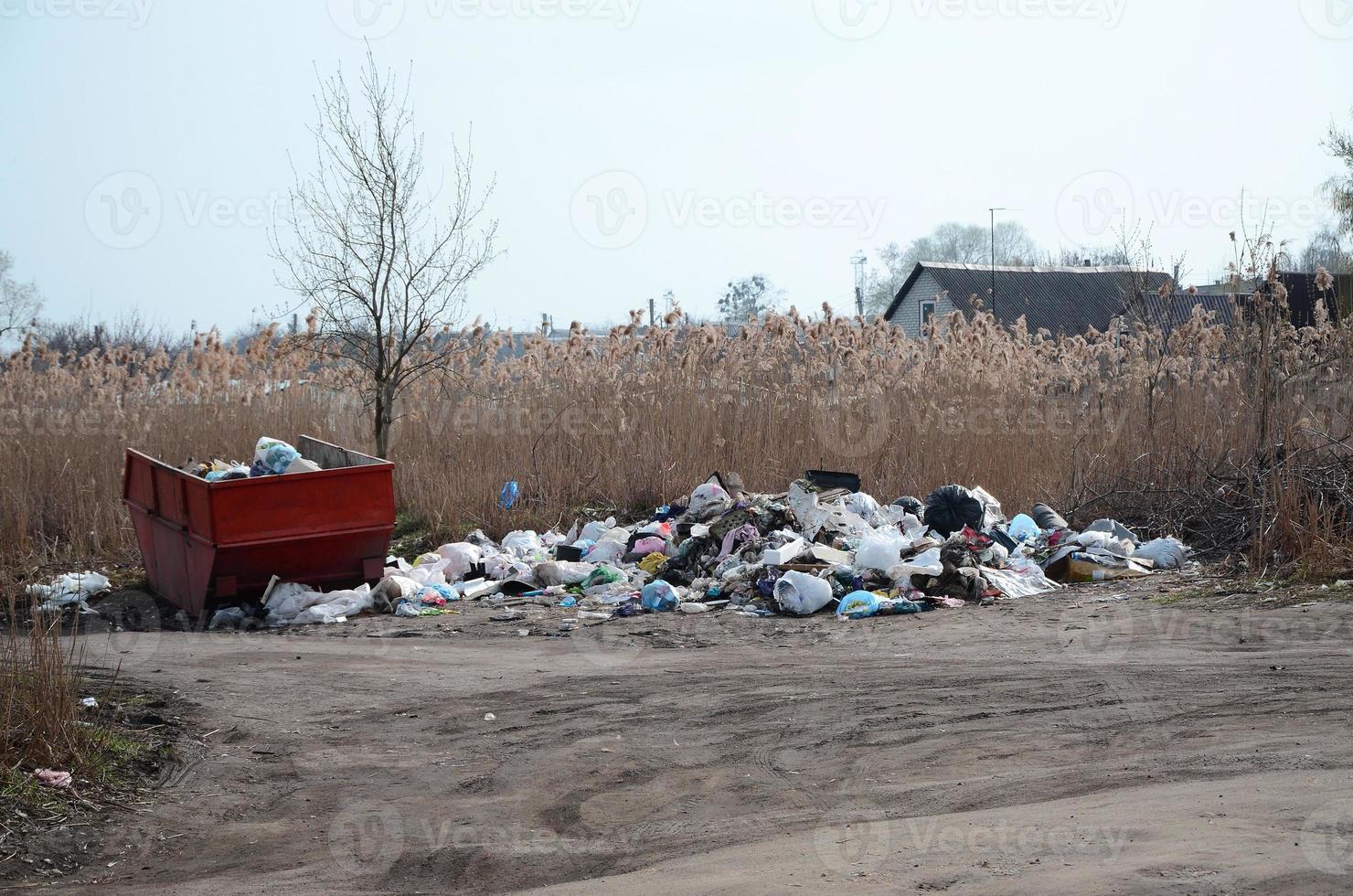 Garbage can is packed with garbage and waste. Untimely removal of garbage in populated areas photo