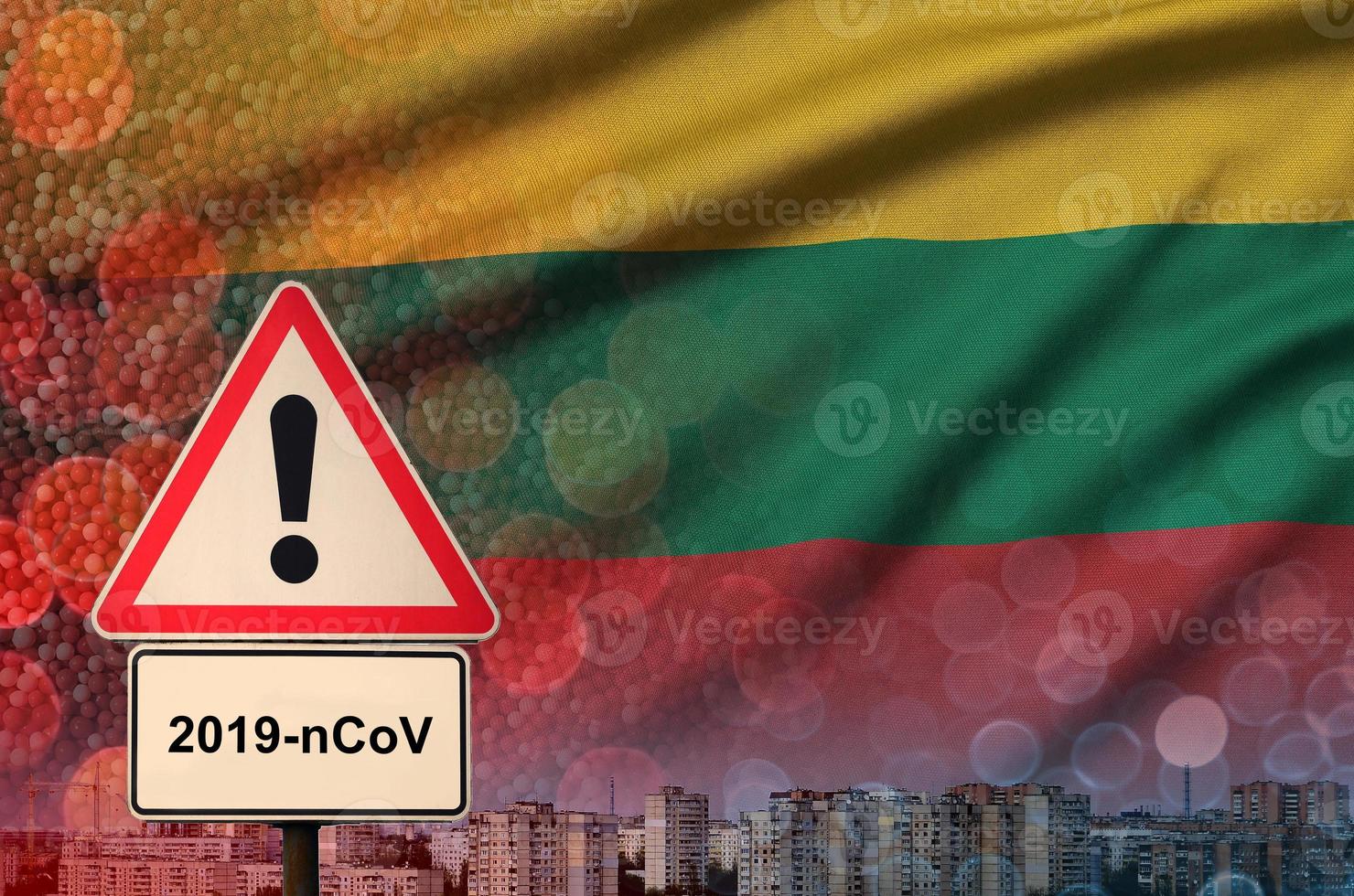 Lithuania flag and Coronavirus 2019-nCoV alert sign. Concept of high probability of novel coronavirus outbreak through traveling tourists photo
