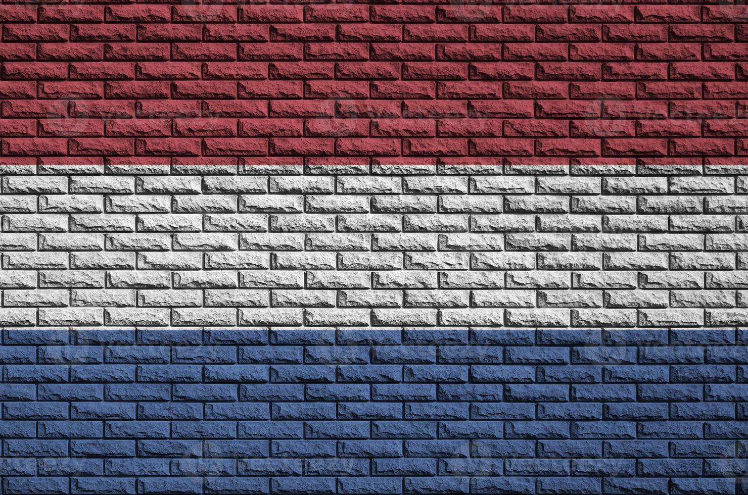 Netherlands flag is painted onto an old brick wall photo