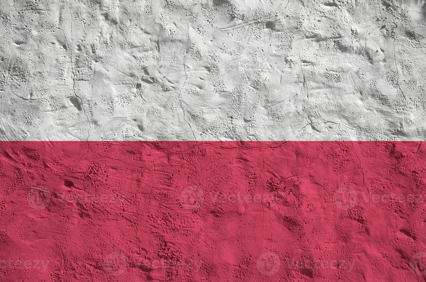 Poland flag depicted in bright paint colors on old relief plastering wall. Textured banner on rough background photo