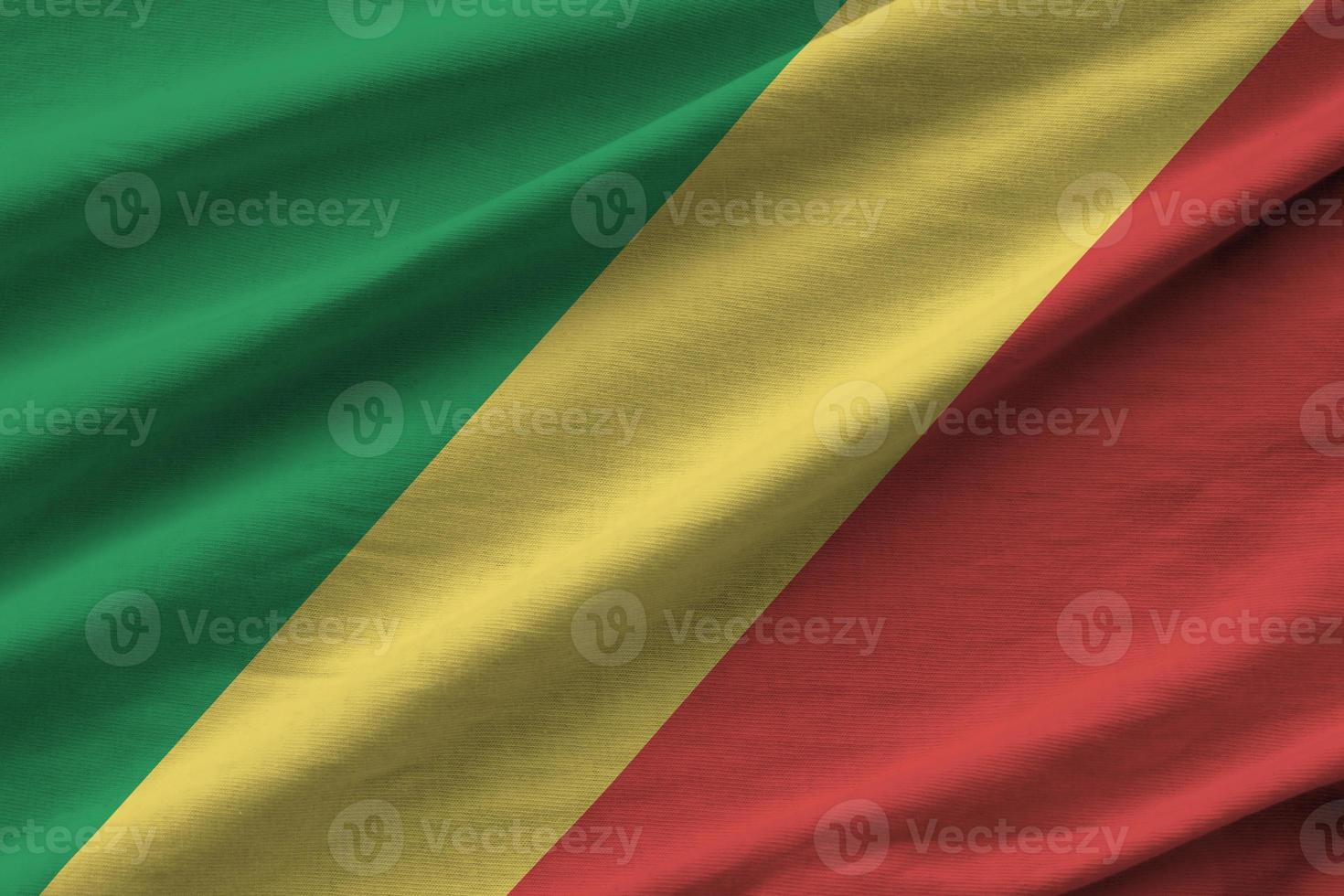 Congo flag with big folds waving close up under the studio light indoors. The official symbols and colors in banner photo