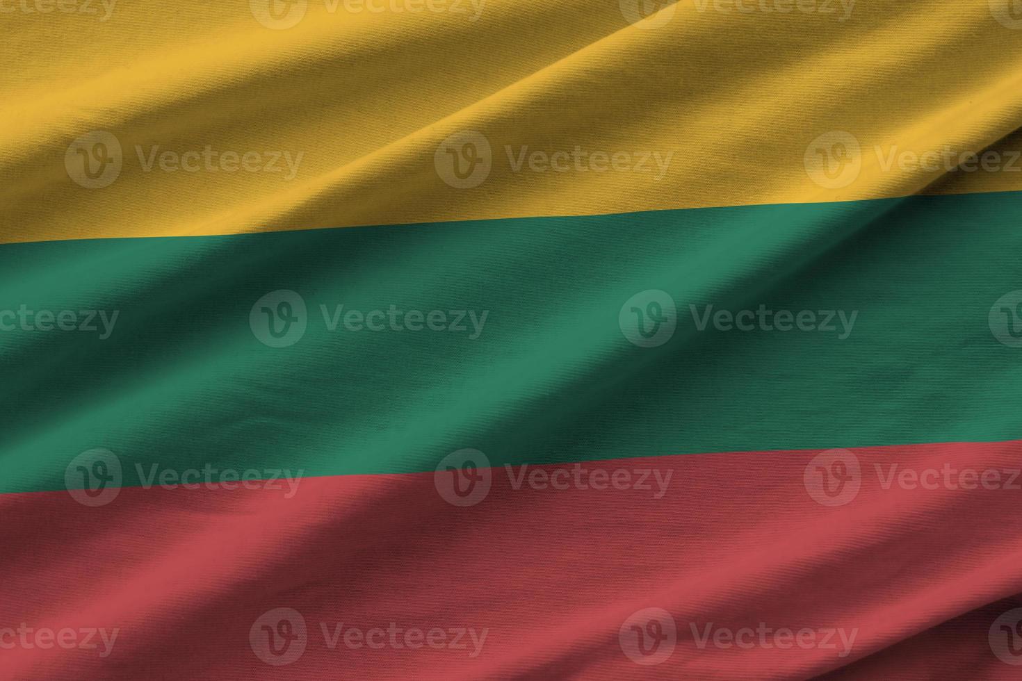 Lithuania flag with big folds waving close up under the studio light indoors. The official symbols and colors in banner photo