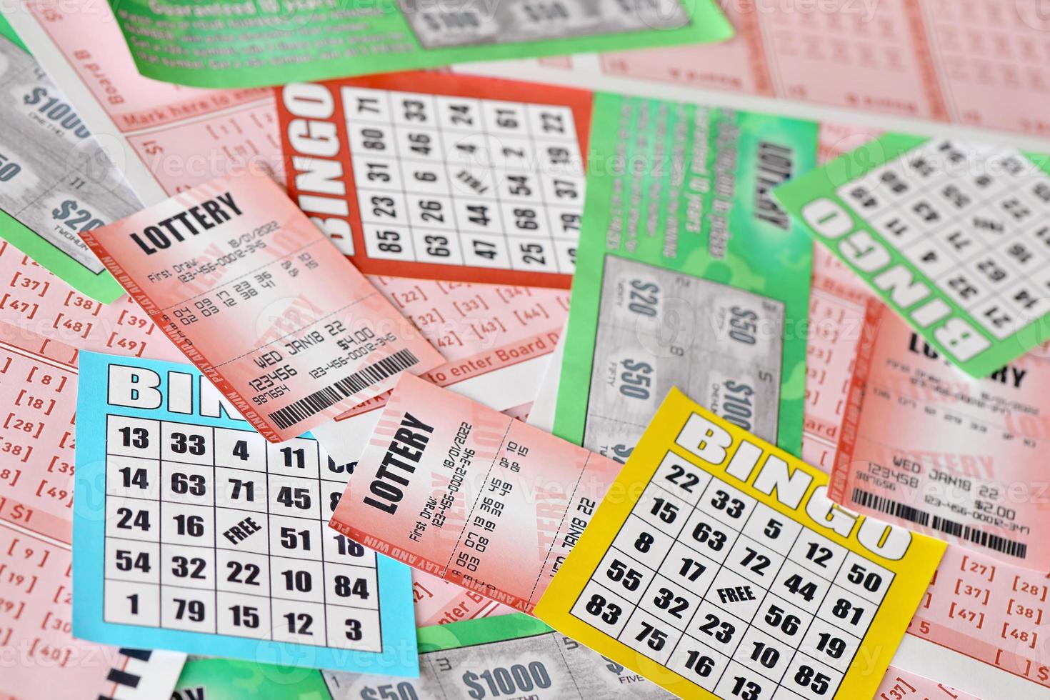 Many used lottery tickets, bills with numbers and bingo playing boards in big pile. Gambling and lottery paper stuff photo