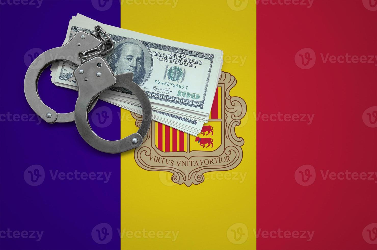 Andorra flag with handcuffs and a bundle of dollars. The concept of breaking the law and thieves crimes photo