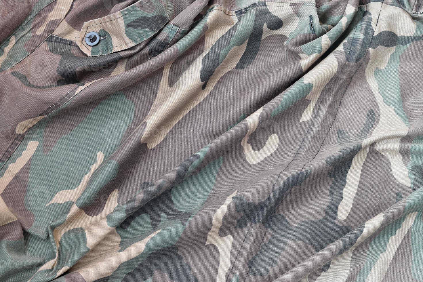 Camouflage background texture as backdrop for military service design projects photo