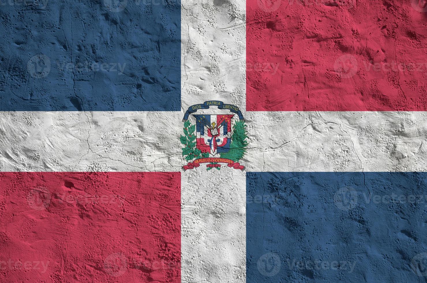 Dominican Republic flag depicted in bright paint colors on old relief plastering wall. Textured banner on rough background photo