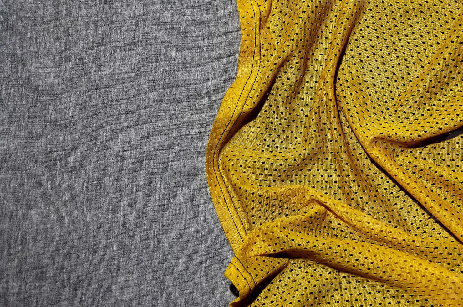 Top view of cloth textile surface. Close-up rumpled heater and knitted fabric texture with a thin striped pattern. Sport clothing fabric texture. Colored basketball shirt and heater hoodie photo