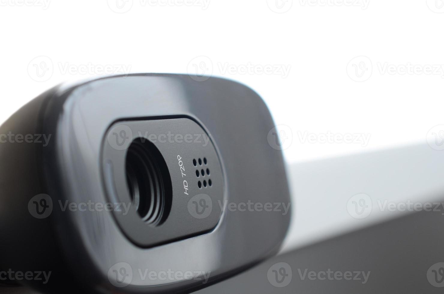 A modern web camera is installed on the body of a flat screen monitor. Device for video communication and recording of high quality video photo