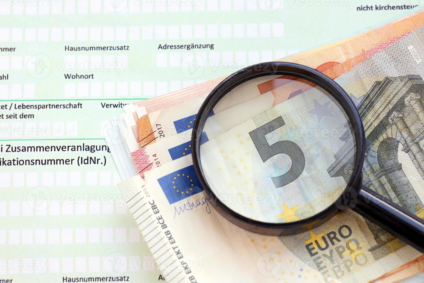 German tax return form with magnifying glass and european euro