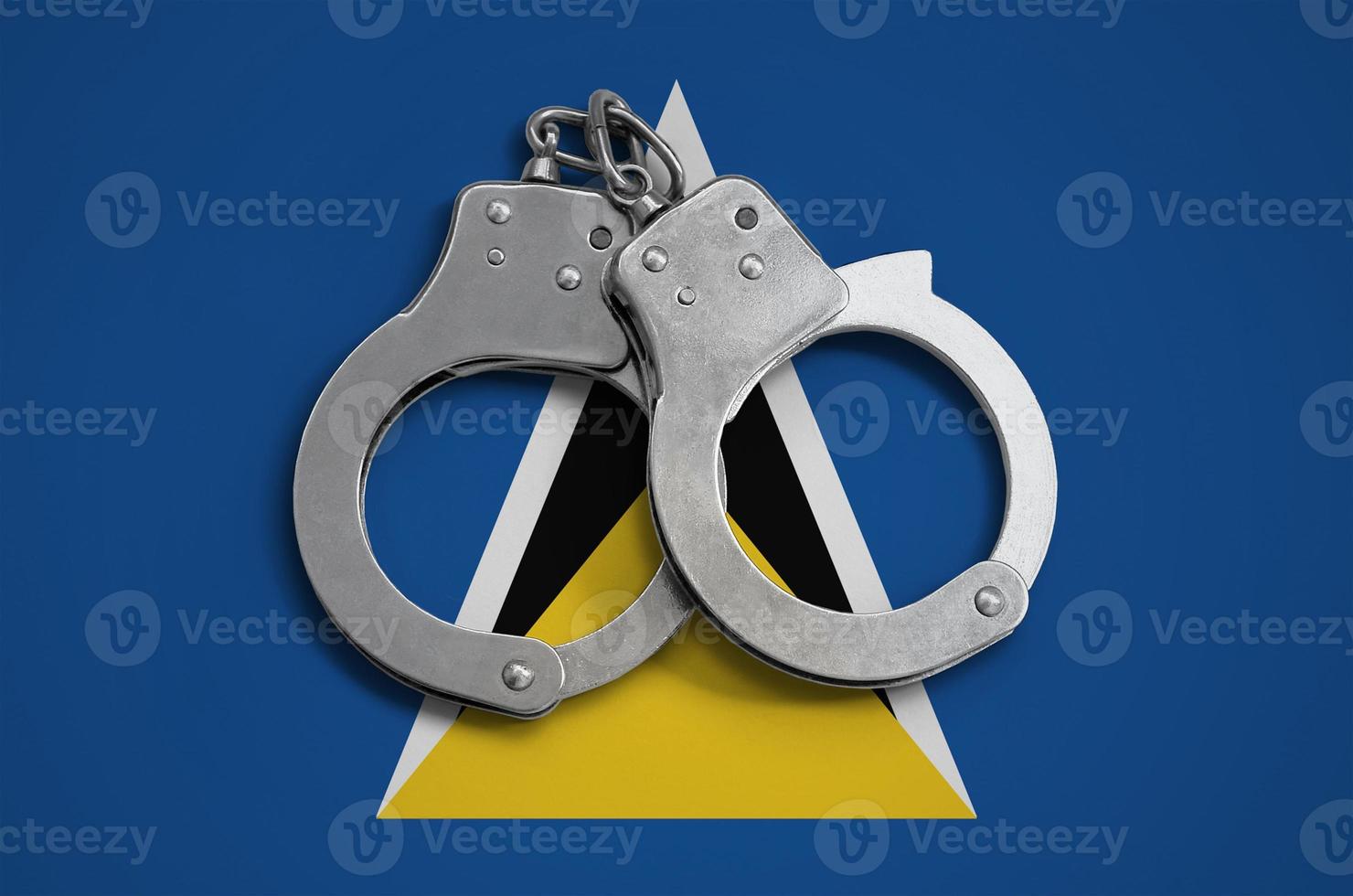 Saint Lucia flag and police handcuffs. The concept of observance of the law in the country and protection from crime photo