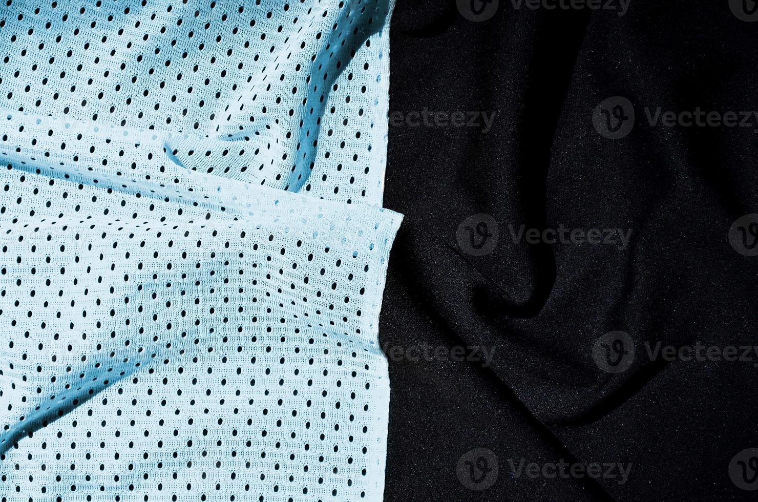 Sport clothing fabric texture background. Top view of light blue polyester nylon cloth textile surface. Colored basketball shirt with free space for text photo