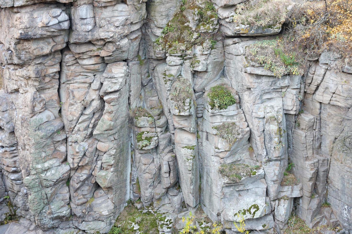 Light coarse natural rock stone background. Mining cliff rough front surface. Big limestone stack backdrop. Heavy grunge damaged granite block texture photo