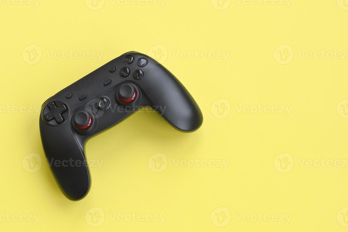 Modern black gamepad on yellow background. Esports and cyber sport tournament concept photo