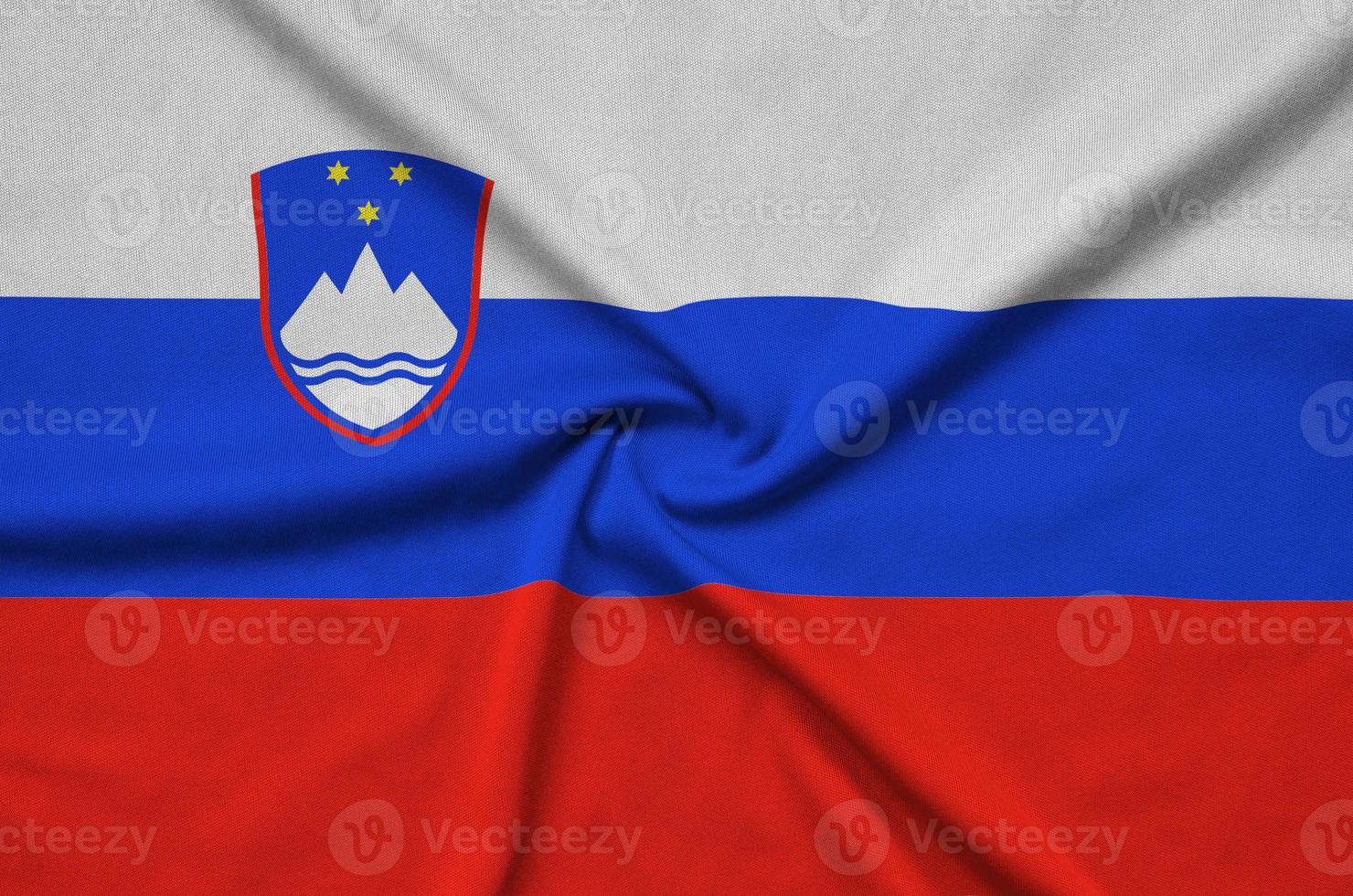 Slovenia flag is depicted on a sports cloth fabric with many folds. Sport team banner photo