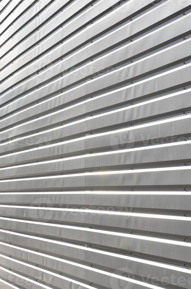 The texture of the wall is made of metal coating of huge aluminum plates of relief shape photo