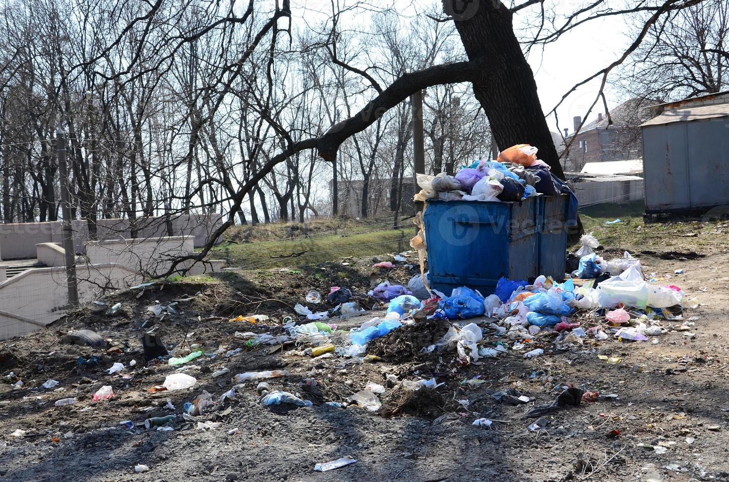 The garbage can is packed with garbage and waste. Untimely removal of garbage in populated areas photo