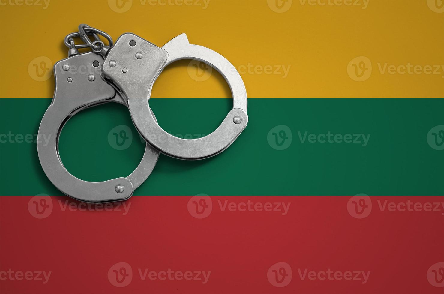 Lithuania flag and police handcuffs. The concept of crime and offenses in the country photo