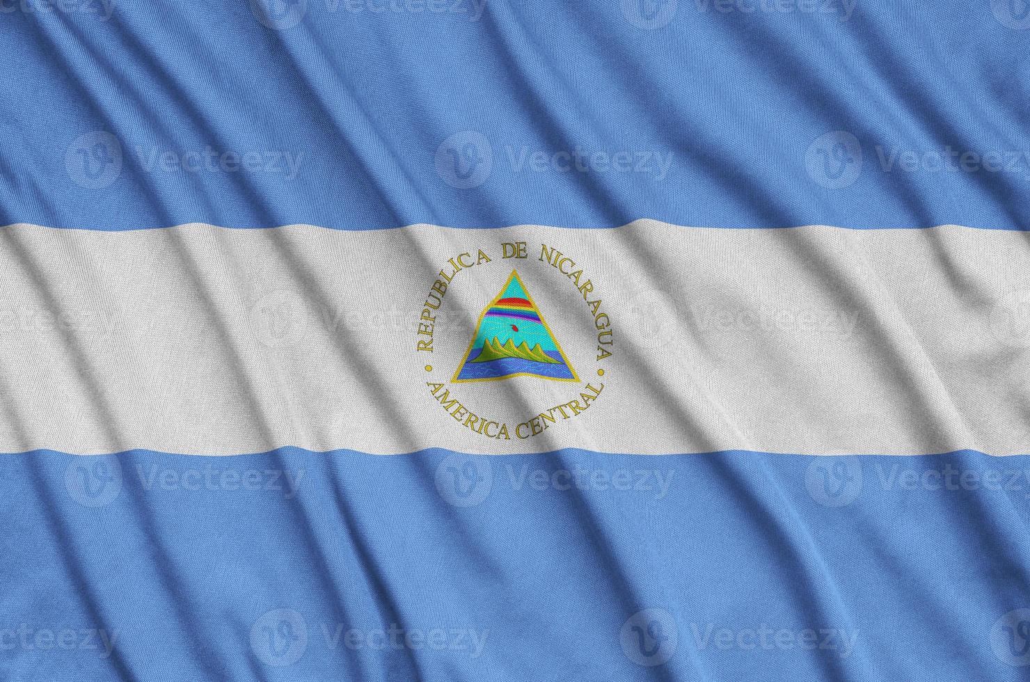 Nicaragua flag is depicted on a sports cloth fabric with many folds. Sport team banner photo
