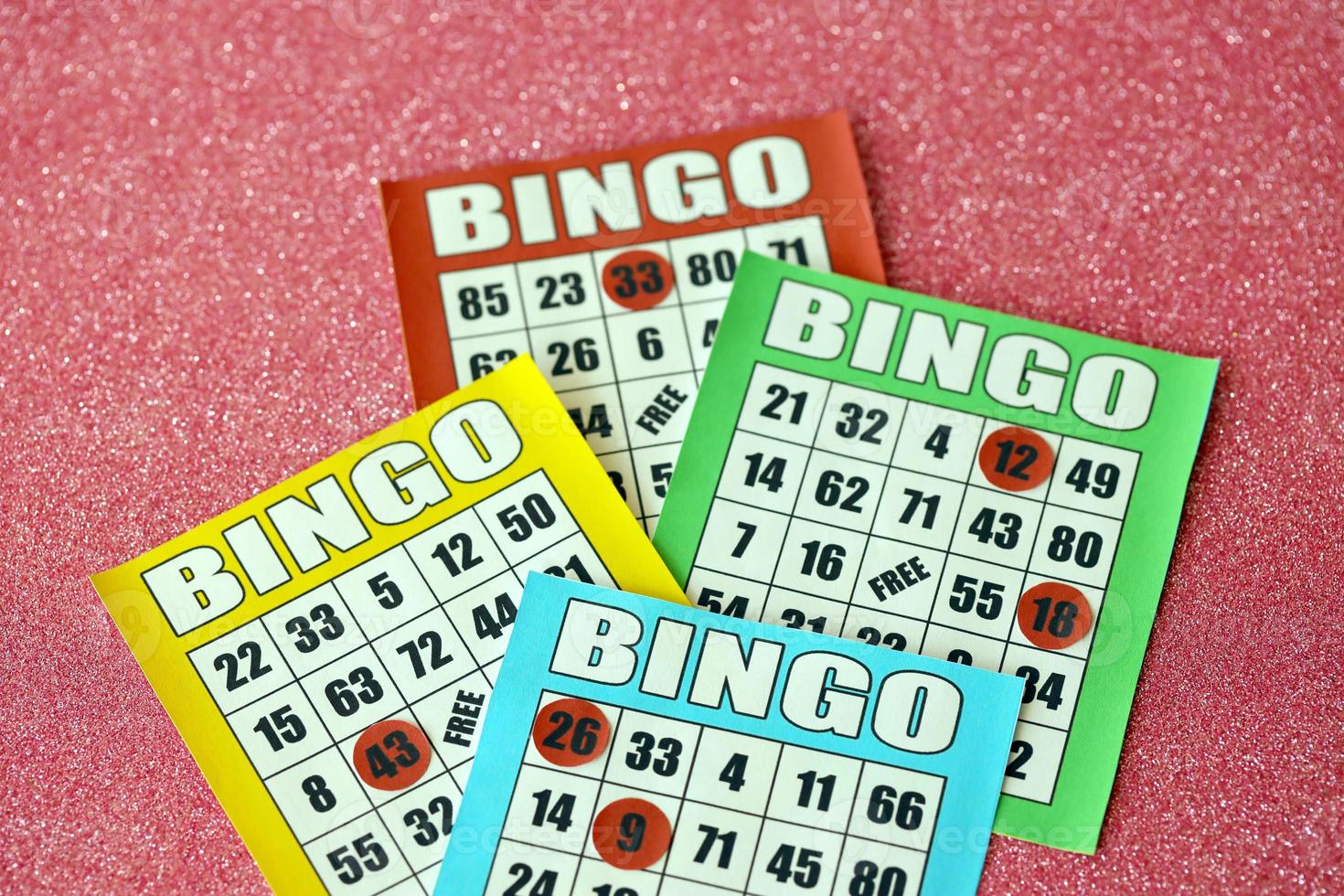 Many colorful bingo boards or playing cards for winning chips. Classic US or canadian five to five bingo cards on bright background photo