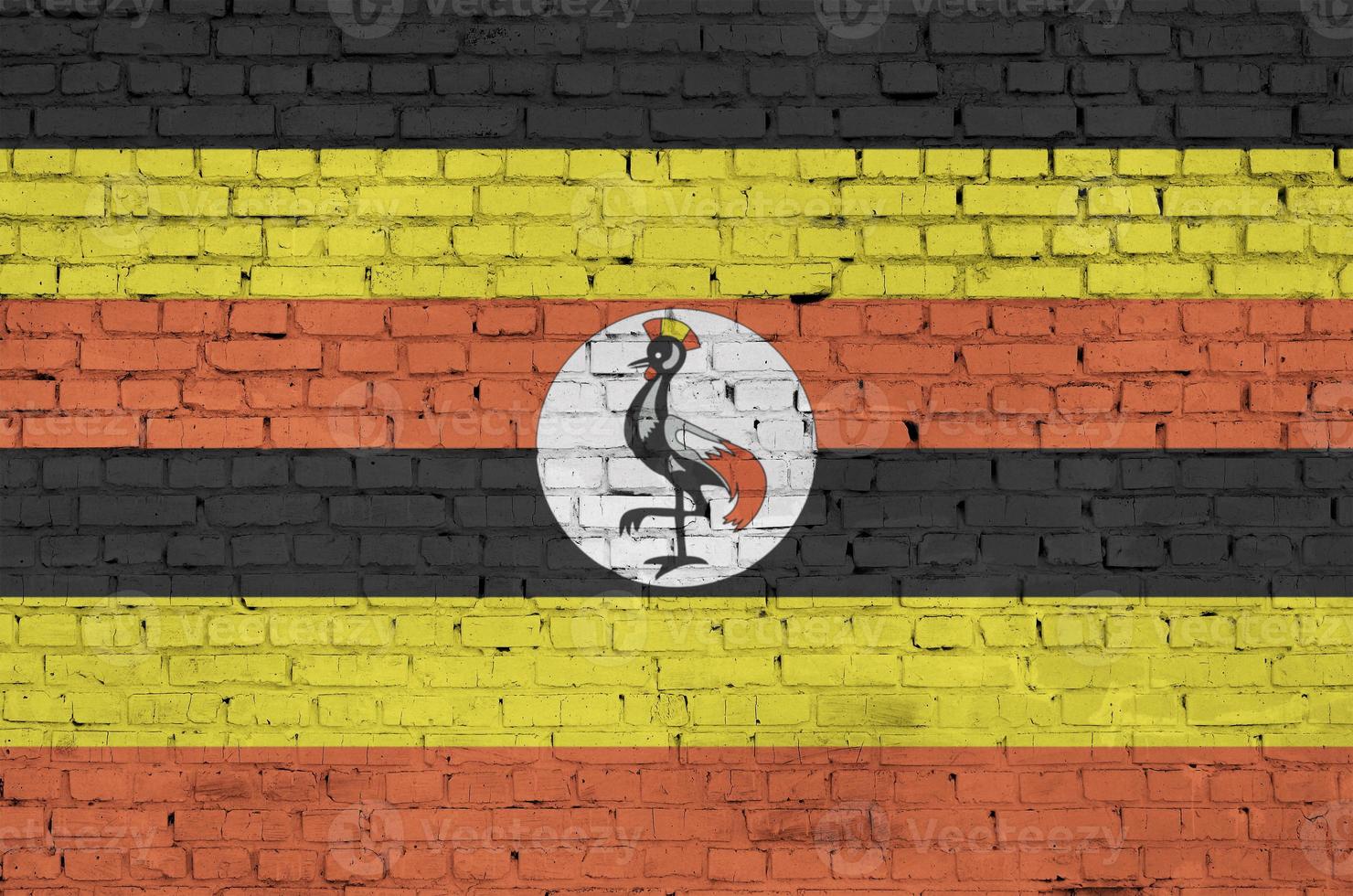 Uganda flag is painted onto an old brick wall photo