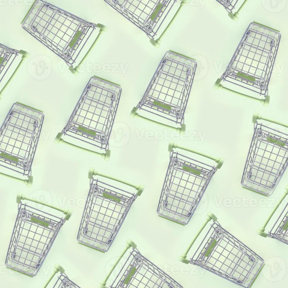 Pattern of many small shopping carts on a lime background photo