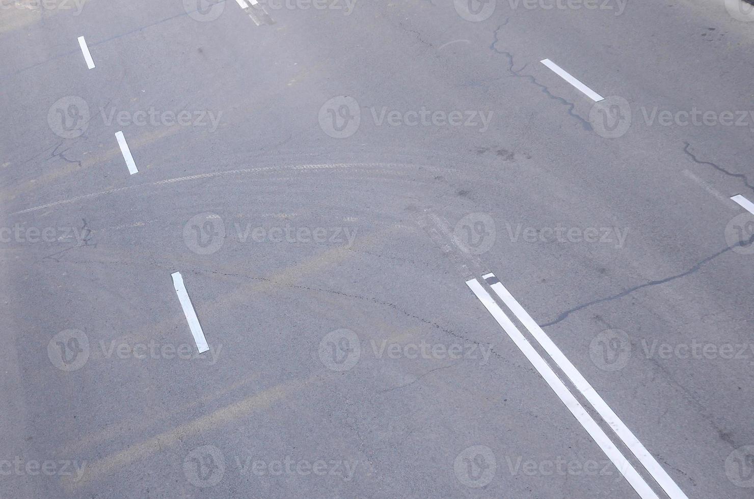Damaged bad asphalt road with potholes. Patch repair of asphalt photo