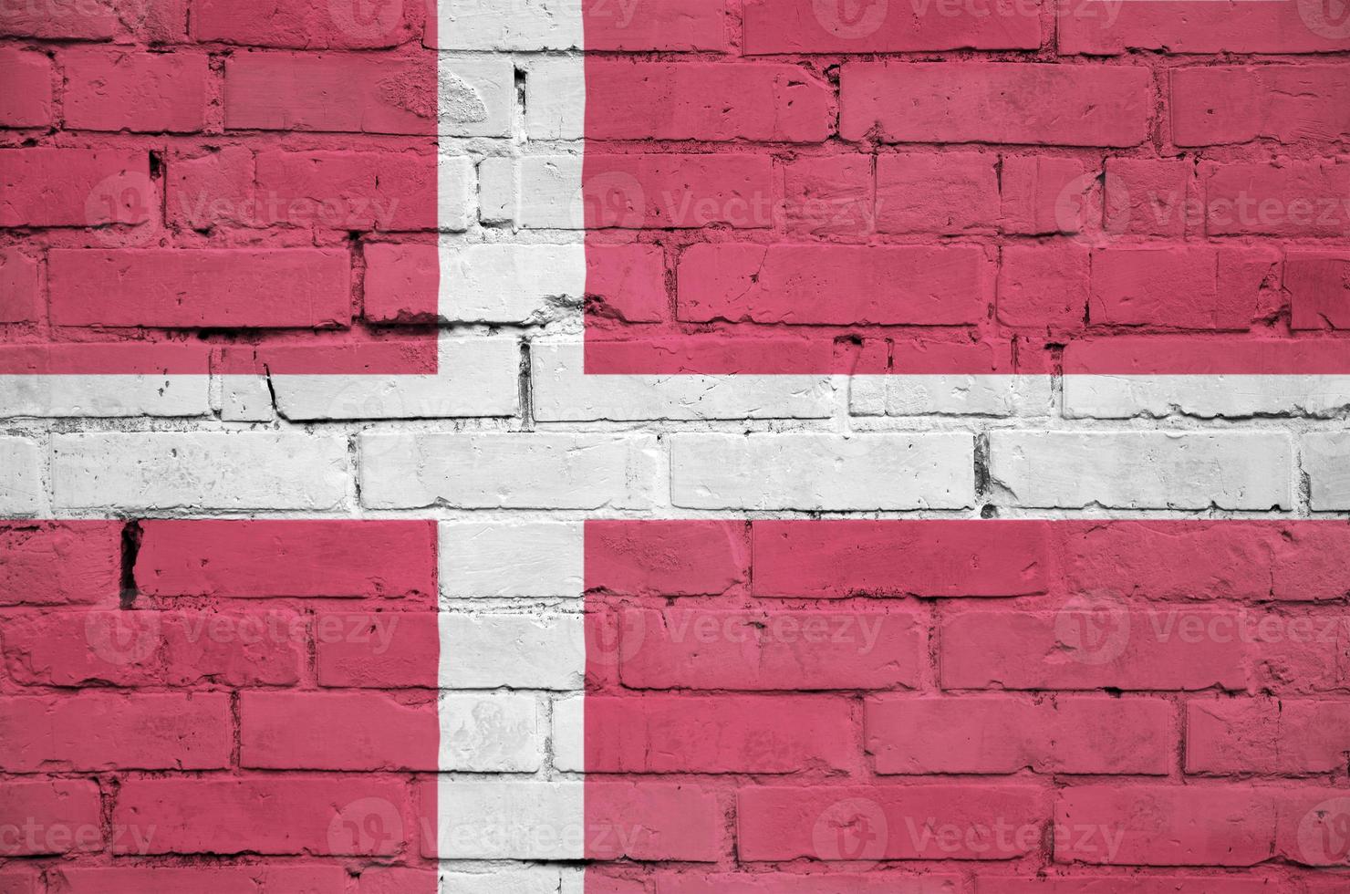 Denmark flag is painted onto an old brick wall photo