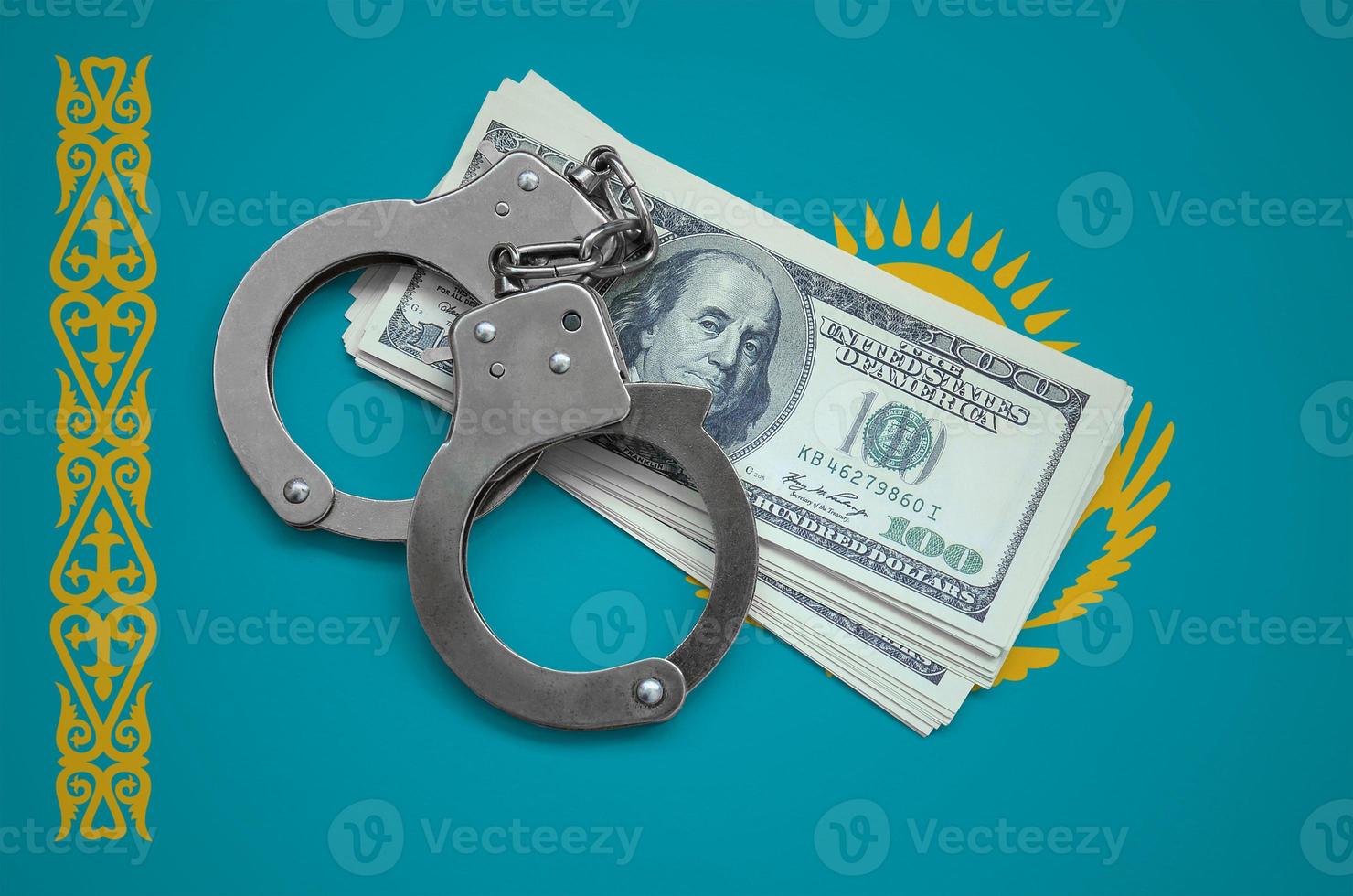 Kazakhstan flag with handcuffs and a bundle of dollars. Currency corruption in the country. Financial crimes photo