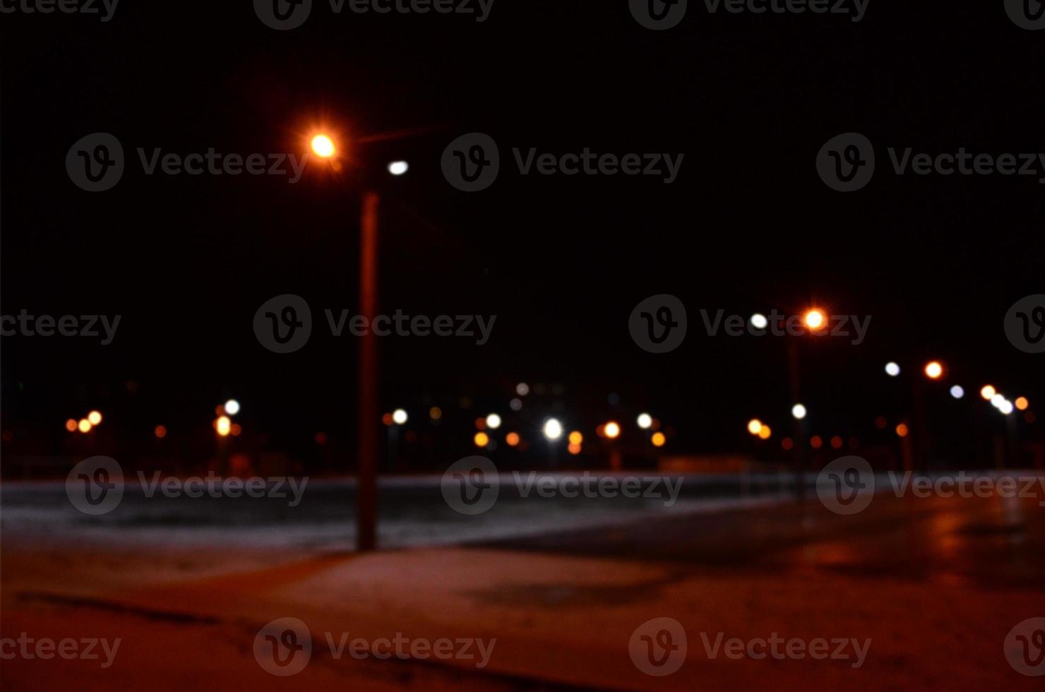 Blurred photo of school playground at night with bright lights