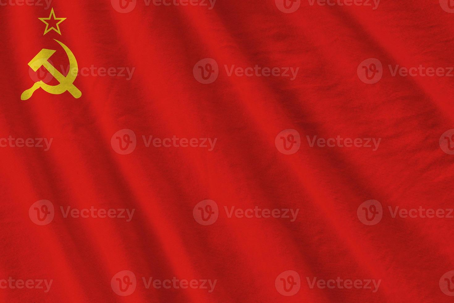 Soviet Union flag with big folds waving close up under the studio light indoors. The official symbols and colors in banner photo