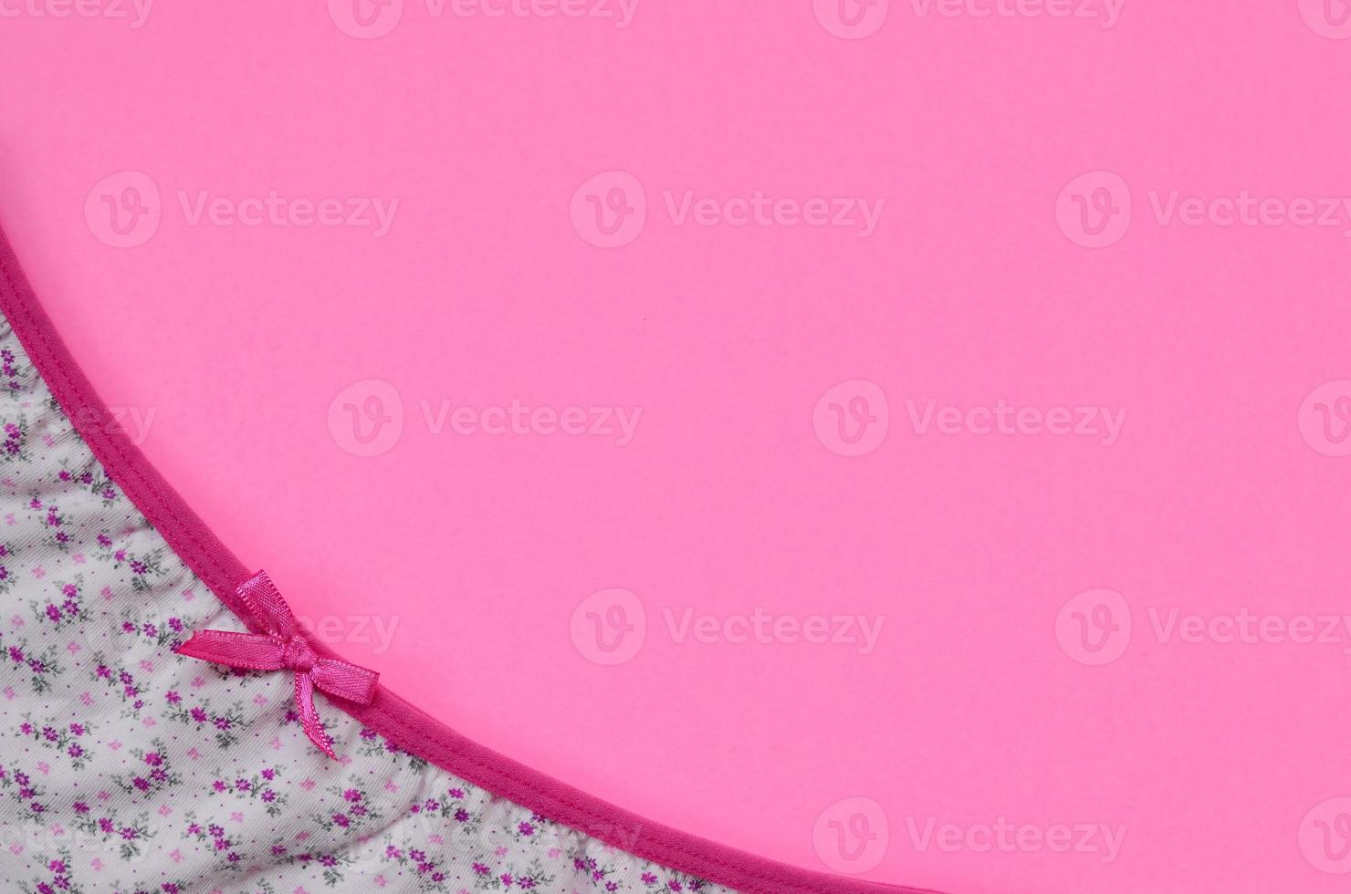 Ribbon on white women underwear with lace on pink background with copy space. Beauty fashion blogger concept. Romantic lingerie for Valentines day temptation photo