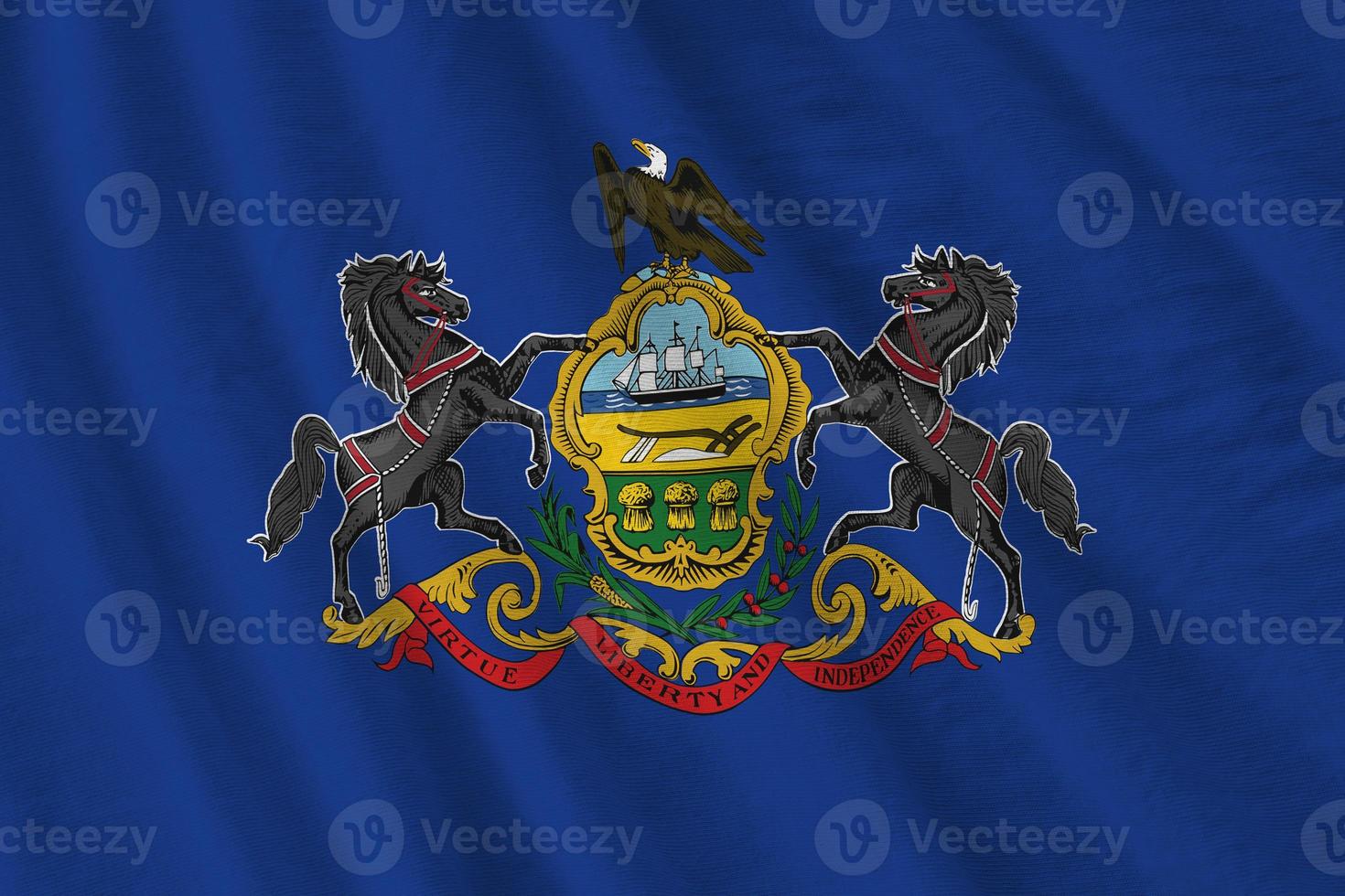 Pennsylvania US state flag with big folds waving close up under the studio light indoors. The official symbols and colors in banner photo