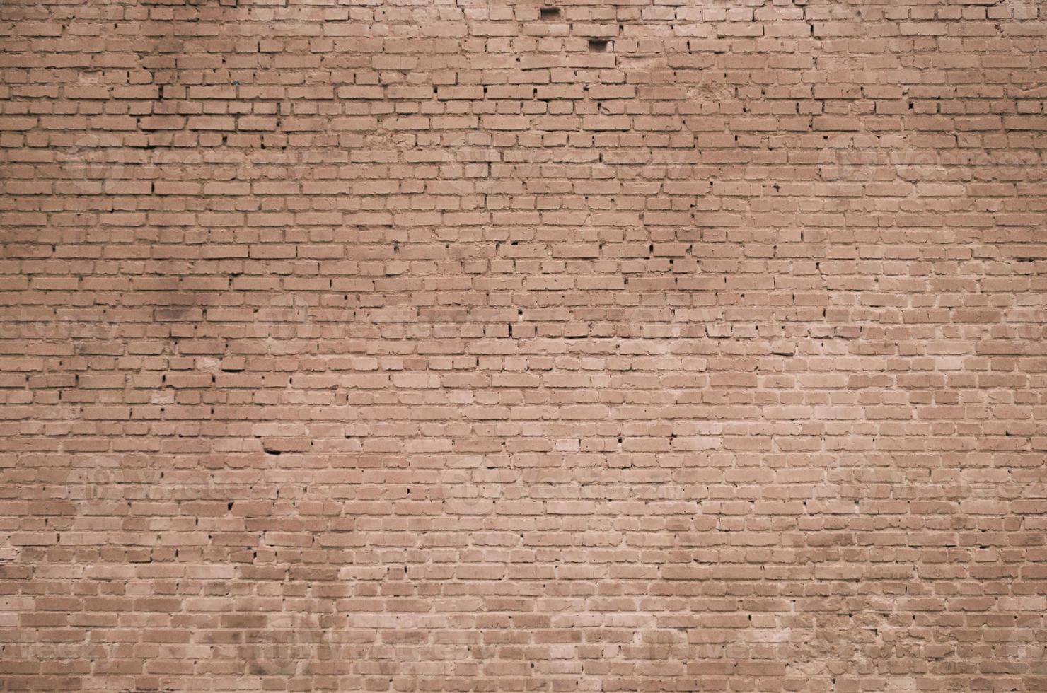 The texture of the brick wall of many rows of bricks painted in brown color photo