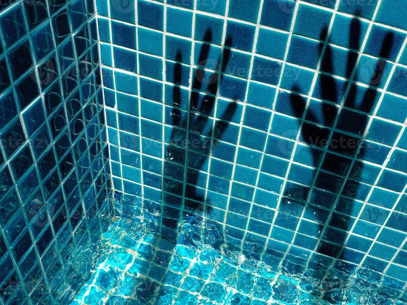 Hand shadows on the pool mosaics photo