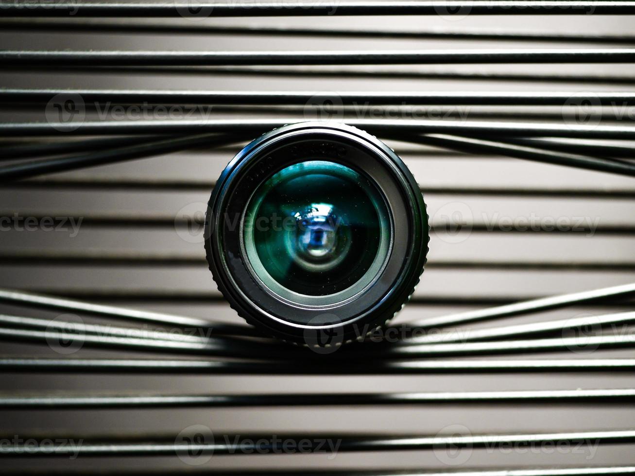 A close-up of a camera lens on elastic plastic strips creating an eye photo