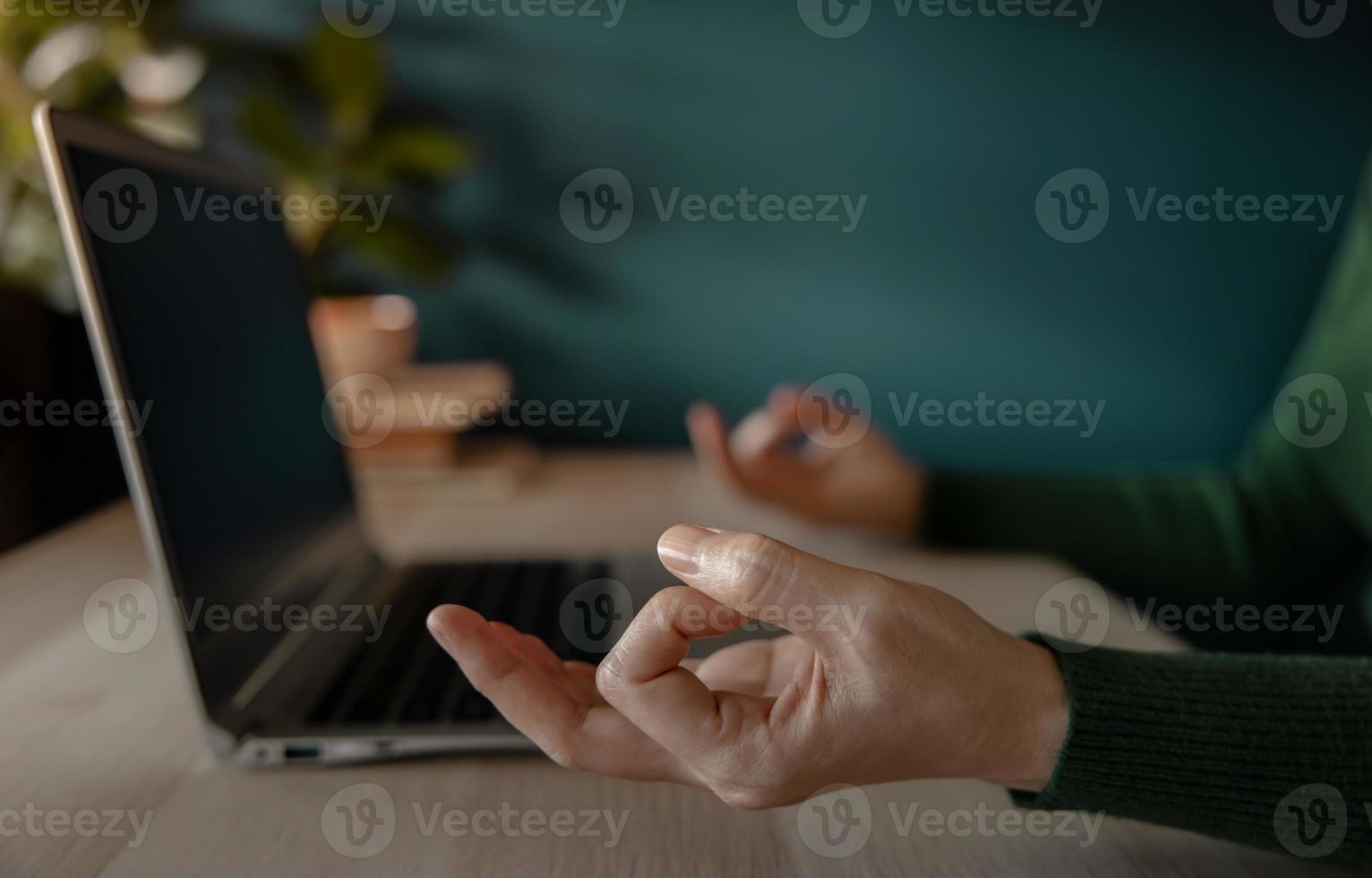 Work Life Balance Concept. Woman sitting on Desk and making the Meditation while Working on Computer Laptop. Mental Health and Calm thoughtful. Slow Down from Stress Work photo