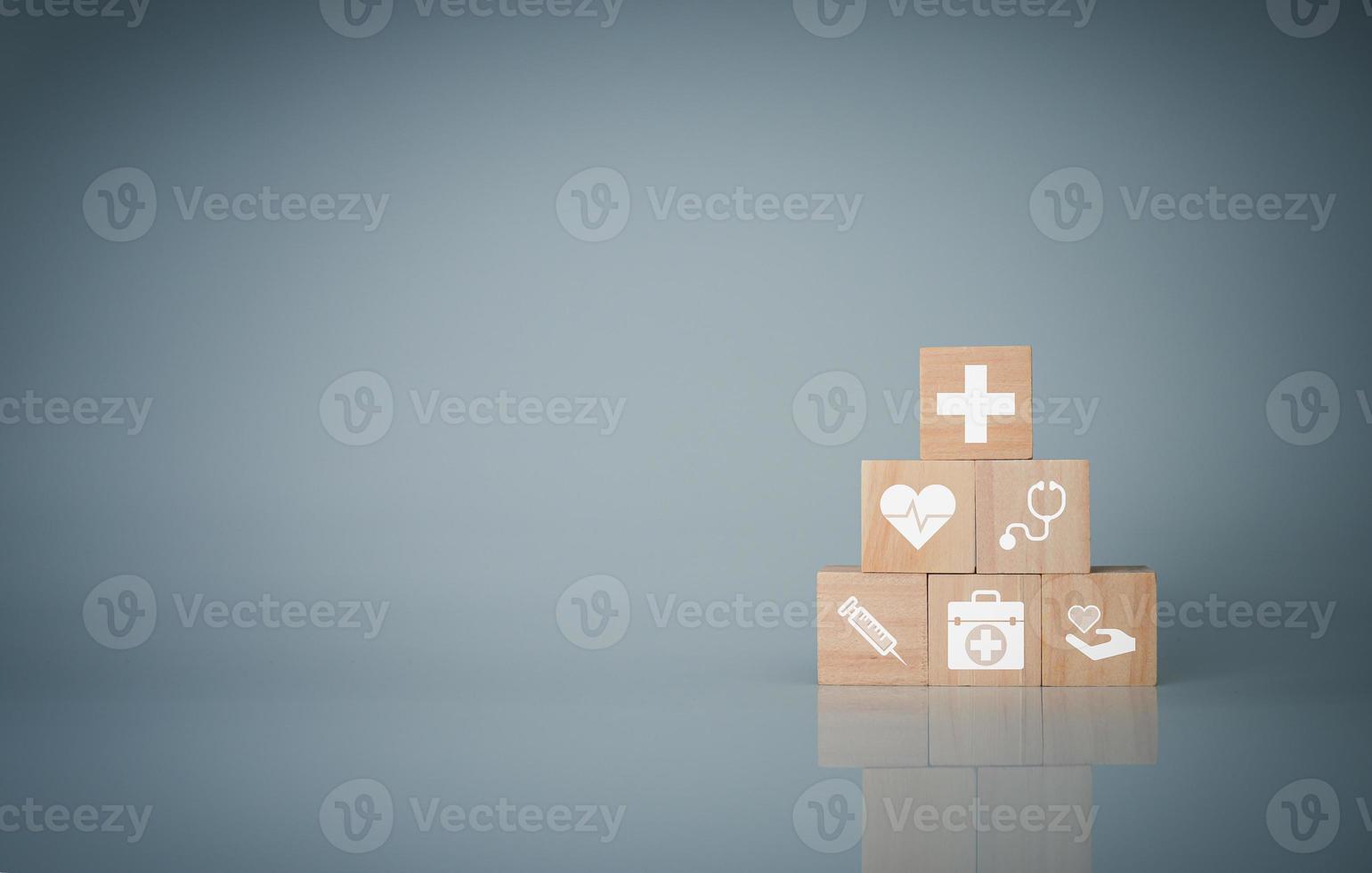Wooden cube blocks stacked with icons. Health and Medicine Concepts. photo