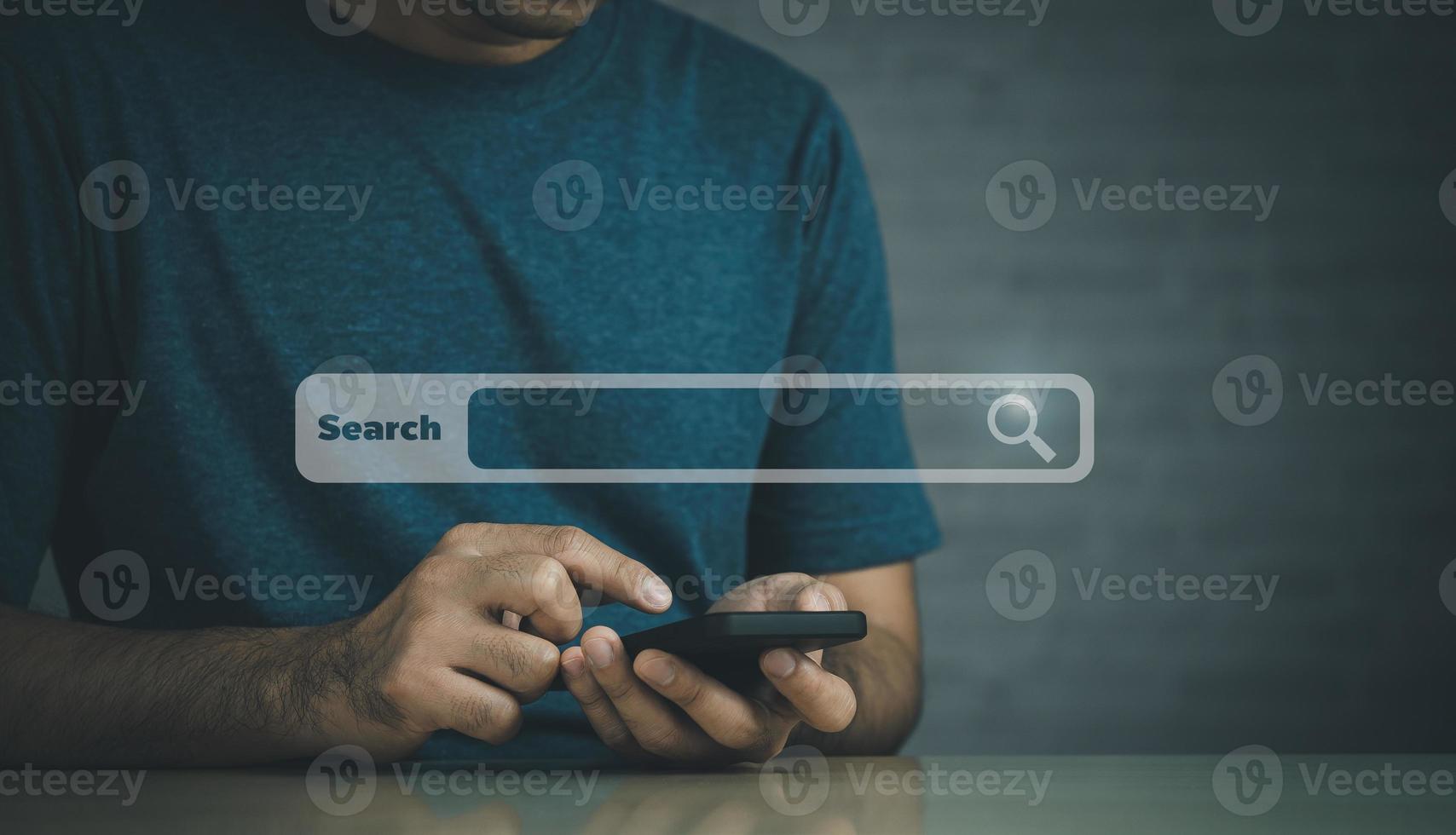 Businessman use mobile phone searching browsing internet data information with blank search bar. Search engine optimization SEO networking concept. businessman working with smartphone on desk. photo