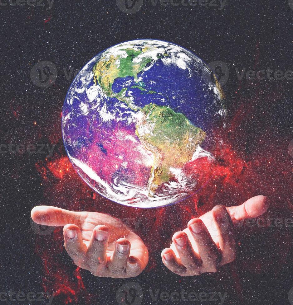 Earth and environment in hand on black background. Love the earth concept, protect the environment, earth day photo