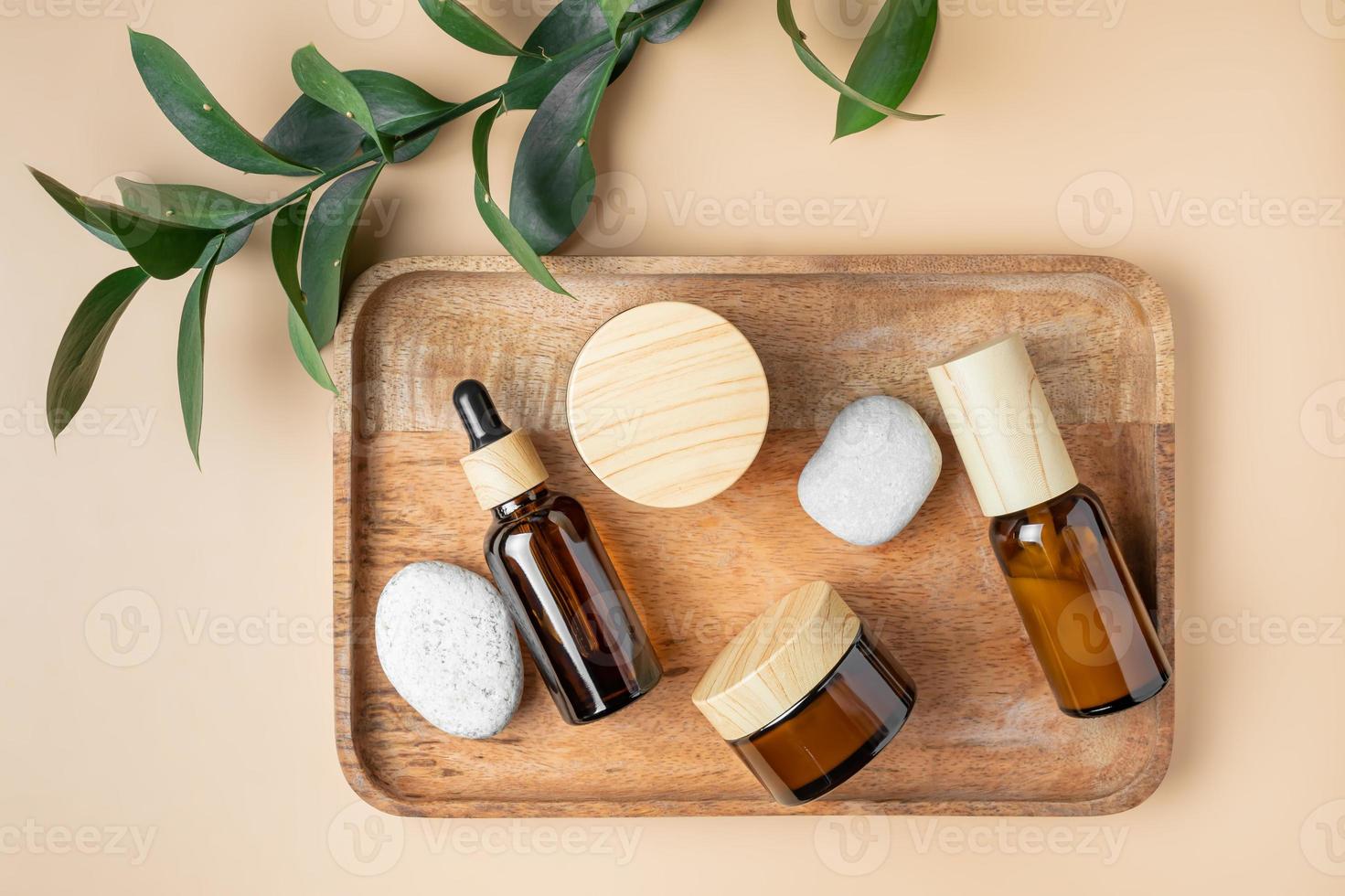 cream jar and dropper bottle with face oil on a wooden tray. Cosmetic container mock-ups. Background for branding and packaging presentation. Natural skincare beauty SPA product concept. photo