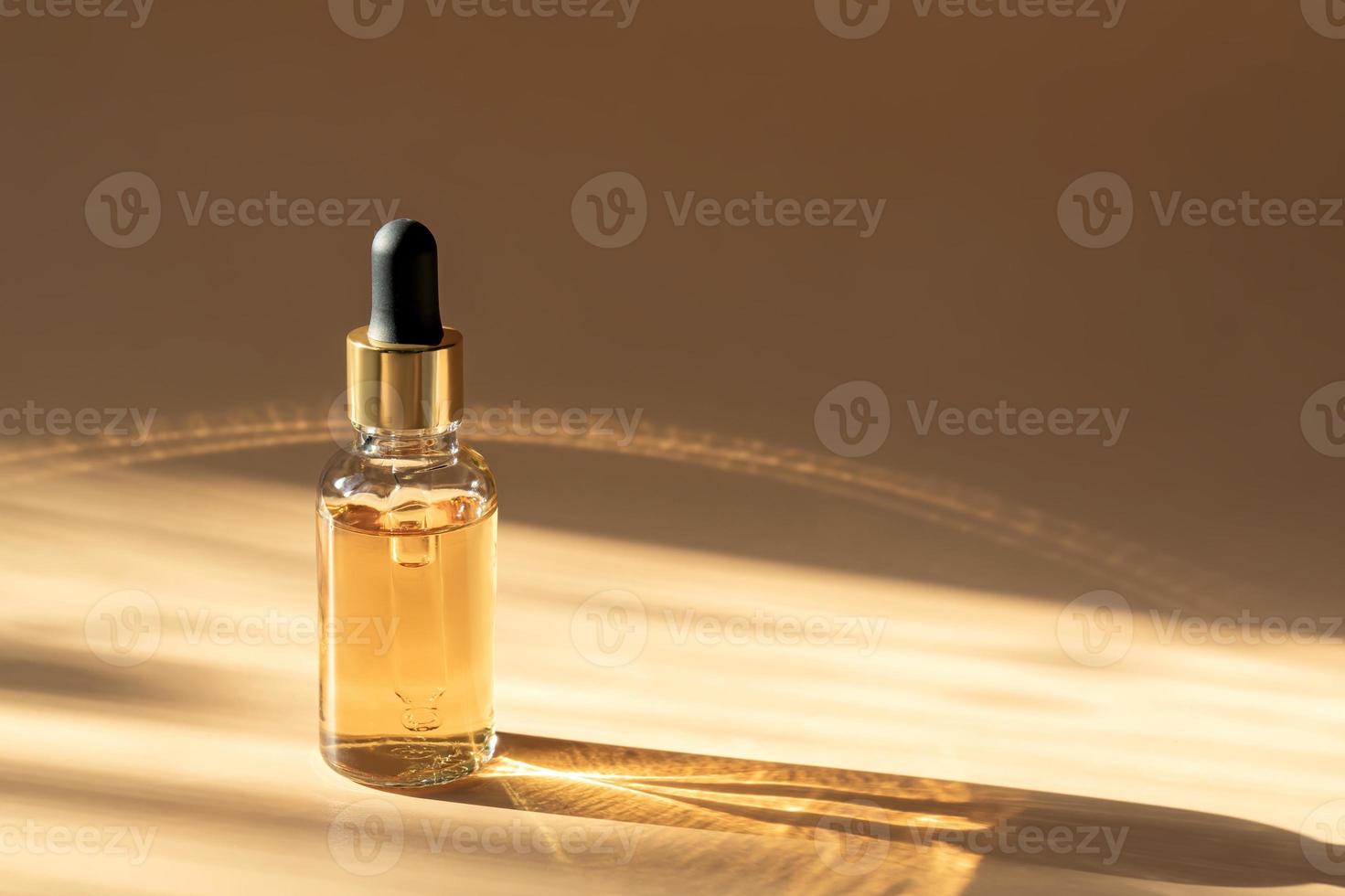 Dropper glass Bottle Mock-Up. dropper pipette with serum or essential oil on beige backgound with caustic shadows for product presentation. Skincare cosmetic. Beauty concept for face body care. photo