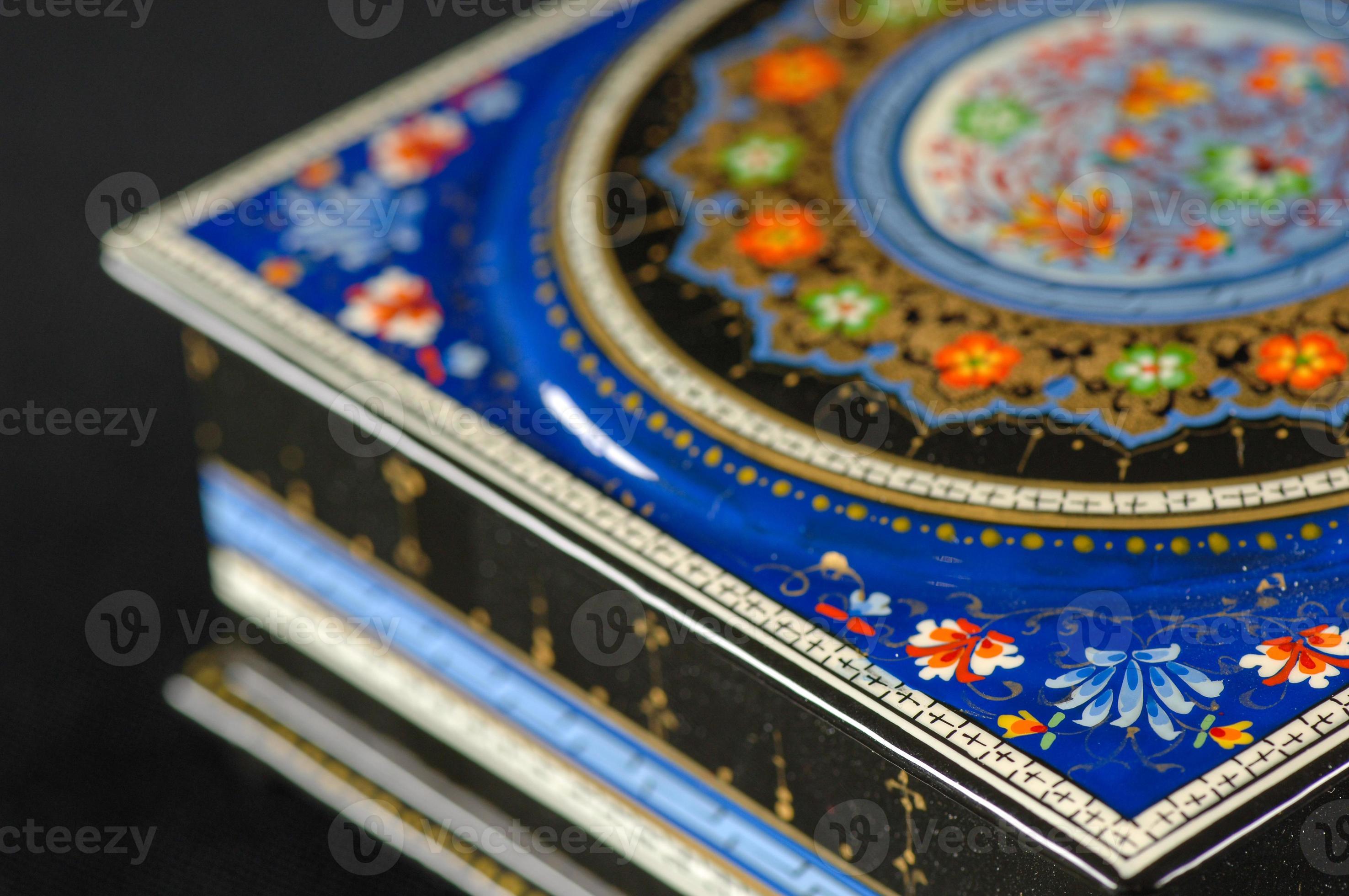 A closeup of a casket with an artistic painting on a black background 