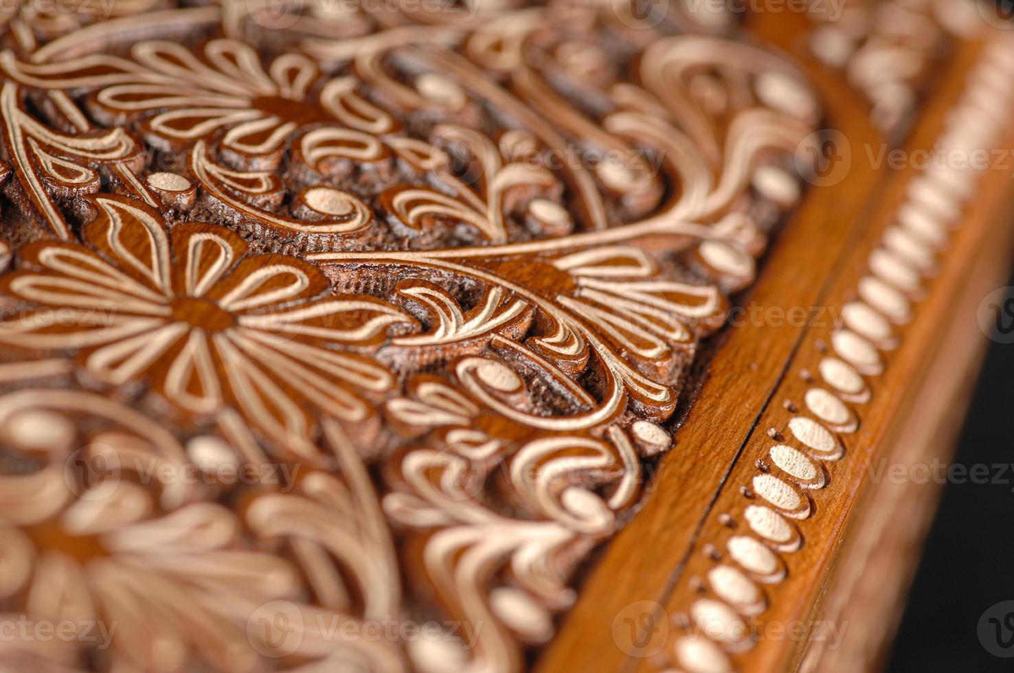 The close-up vintage oriental wooden table with the artistic carving, Uzbekistan photo