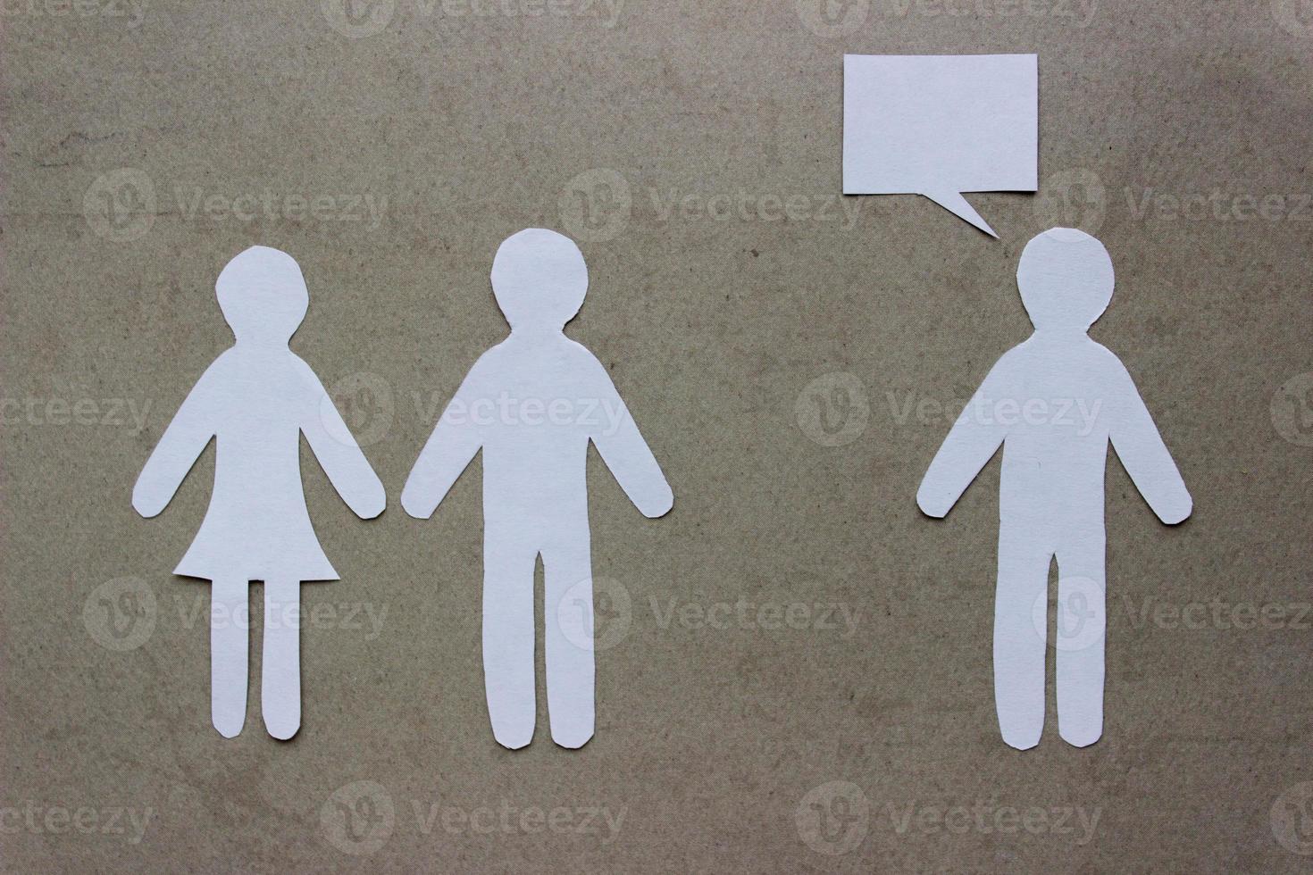 Silhouettes of people cut from paper. Couple holding hands and next to a lonely man. The concept of relationships, love, jealousy, loneliness, treason photo